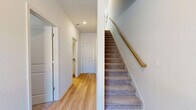 Located at 1104 Avondale Ave SE in Atlanta, GA, this contemporary three-story townhome offers three bedrooms, four bathrooms, and a thoughtfully designed layout distributed across three distinct levels. The entry-level garage features clean white walls, a concrete floor, and utility access, providing secure parking and additional storage.

The main living floor serves as the heart of the home, combining a living room, dining area, and kitchen in one open, airy layout. The kitchen is outfitted with white shaker cabinets, granite countertops, a subway tile backsplash, stainless steel appliances including a gas range and built-in microwave, and light hardwood flooring that flows seamlessly into the dining and living spaces. The living room benefits from a ceiling fan and a bright, neutral palette, creating a welcoming and functional gathering area.

The upper floor hosts the bedrooms, including a primary suite with plush carpet, a dedicated en-suite bathroom featuring granite vanity countertops and white cabinetry, and a closet. Additional bedrooms are well-proportioned with natural light from large windows. Four full bathrooms throughout the home ensure ample convenience. A dedicated laundry closet with a full-size washer and dryer adds practical day-to-day ease. The consistent use of light hardwood flooring, neutral tones, and clean finishes gives the entire home a cohesive, modern aesthetic.