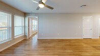 Located at 5004 Dream Dr in Winter Haven, Florida, this well-appointed 2-bedroom, 2-bathroom single-story home offers a thoughtfully designed layout with modern finishes throughout. Warm wood-look flooring flows seamlessly across every room, complemented by neutral-toned walls that create a bright, cohesive aesthetic.

The kitchen is a standout feature, equipped with stainless steel appliances including a range, over-the-range microwave, and refrigerator. Crisp white shaker cabinetry provides ample storage, while granite countertops extend across both the perimeter counters and a central island, offering generous prep and dining space.

The open living area benefits from abundant natural light through large windows and a ceiling fan overhead, with a door providing access to the outdoors and scenic water views visible from multiple rooms.

The spacious primary bedroom includes a walk-in closet and a private en-suite bathroom featuring white vanity cabinetry, granite countertops, a framed mirror, and a shower. The second bathroom mirrors this refined style with a full tub-shower combination and matching finishes.

A dedicated laundry room houses a full-sized Samsung washer and dryer. Two closets provide additional storage throughout the home. The layout also includes a hallway connecting all rooms efficiently, making this a highly functional and comfortable residence.