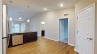 Located at 65 Hawthorne Gate Dr in Dayton, Ohio, this single-story home combines functional design with quality finishes throughout. The open-concept living area features vaulted ceilings and hardwood-style flooring, creating a bright and airy atmosphere enhanced by natural light from large windows with exterior views. A ceiling fan adds both style and practicality to the space.

The kitchen is well-equipped with rich, dark espresso cabinetry, granite countertops, and a full suite of stainless steel appliances, including a refrigerator, range, microwave, and dishwasher. Pendant lighting over the sink area adds a refined touch, while the open layout allows for a seamless flow into the adjoining living space.

The primary bathroom features a double-sink vanity with granite countertops, dark cabinetry, and large mirrors, along with access to a walk-in closet fitted with wire shelving systems. A secondary bathroom includes a single granite-topped vanity and a full tub-shower combination. Bedrooms are carpeted and include ceiling fans and ample natural light. A dedicated laundry room with upper cabinetry and wood-style flooring rounds out the layout, providing additional storage and utility.