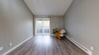 Located at 2728 Schley Blvd in Bremerton, WA, this single-floor, three-bedroom, one-bathroom home offers a practical and comfortable layout with consistent modern finishes throughout. Light-toned wood-look flooring runs seamlessly across the living areas and bedrooms, complemented by neutral gray walls and crisp white trim that create a clean, cohesive aesthetic.

The open-plan kitchen and living area serves as the heart of the home. The kitchen features white shaker-style cabinetry, granite-look countertops, a stainless steel sink, and white appliances including a range, dishwasher, and refrigerator. The living area benefits from a sliding glass door that floods the space with natural light and opens directly onto a private balcony with outdoor views.

A central hallway connects the three bedrooms, each finished with wood-look flooring, neutral walls, and ample closet space — with five closets total across the home. The bedrooms receive natural light through well-sized windows, and baseboard heating is present throughout. The bathroom includes a tub/shower combination with clean white finishes.

Additional highlights include an in-unit laundry area and a textured ceiling detail in select rooms. The overall design is understated and functional, offering a move-in-ready environment in a convenient Bremerton location.