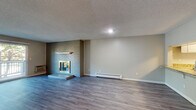 Located at 4982 S Ulster St in Denver, CO, this single-floor unit offers a well-designed layout with a variety of functional and comfortable living spaces. The open living area is a standout, featuring durable wood-look flooring, a classic brick fireplace with a raised hearth, and baseboard heating. A sliding glass door provides access to a private balcony, filling the space with natural light and offering outdoor views.

The kitchen is thoughtfully appointed with white shaker-style cabinetry, granite countertops, stainless steel appliances including a range, over-the-range microwave, refrigerator, and dishwasher, complemented by a blue accent wall that adds a pop of color.

The bedrooms are carpeted for comfort and each feature mirrored sliding closet doors and ceiling fans. Natural light filters in through windows fitted with blinds, and baseboard heating ensures year-round comfort.

The bathrooms are clean and functional, with one featuring a full tub-shower combination and wood-look flooring. A secondary bathroom area includes a vanity with ample counter space and storage. The textured ceilings and neutral color palette throughout create a cohesive, move-in-ready environment.