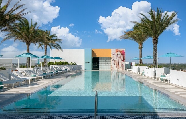 Enjoy our serene rooftop pool oasis with cabanas and lawn space - Core Link at Douglas