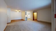 Located at 302 Parkwood Ln in Madison, Wisconsin, this single-floor unit offers a practical and comfortable layout designed for everyday living. The open living area is generously sized, featuring neutral carpet, warm wood-tone baseboards, and a ceiling fan overhead. Natural light filters through vertical blinds on a large window, adding brightness to the space. The living area transitions seamlessly into a dedicated dining space, with easy-care hardwood-style flooring connecting the two zones.

The kitchen is well-appointed with gray shaker-style cabinetry, light countertops, and white appliances including an electric range and dishwasher. Under-cabinet lighting enhances functionality, while the hardwood-style flooring and double-basin sink complete the practical setup.

The bedroom is a calm, carpeted retreat filled with natural light from a wood-trimmed window. It features two full-width closets with sliding and bi-fold doors, offering substantial storage with built-in hanging rods.

The bathroom includes hardwood-style flooring, a full tub-shower combination, a vanity with ample drawer storage, light countertops, and a wall-mounted mirror cabinet. Baseboard heating is present throughout, ensuring comfort year-round in the Madison climate.