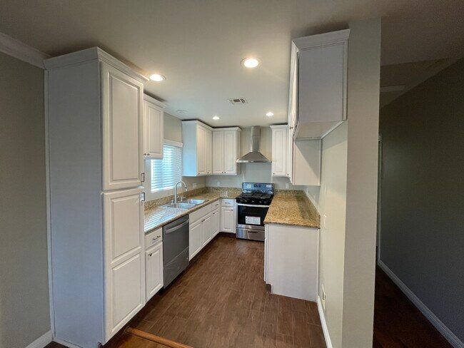 Newly renovated kitchen with brand new range and dishwasher. - 519 E Santa Anita Ave