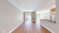 Located at 499 Boston Rd in Billerica, MA, this well-designed one-bedroom, one-bathroom residence offers a thoughtfully organized single-floor layout with a generous mix of living spaces. The open-concept living and dining area is anchored by warm hardwood flooring, crown molding, and multiple windows that invite abundant natural light and views of the surrounding greenery. A peninsula-style kitchen features dark granite countertops, white shaker cabinetry, stainless steel appliances including a refrigerator and range, and an arched architectural detail that leads into a dedicated laundry area with tile flooring. The bedroom is carpeted for comfort, bathed in natural light from a large window with outdoor views, and complemented by a walk-in closet outfitted with wire shelving systems. Two additional closets provide ample storage throughout the unit. A full bathroom includes a soaking tub with tiled surround and chrome fixtures, alongside a granite-topped vanity. A separate office space adds functional versatility. The neutral color palette, clean finishes, and cohesive design create a bright, comfortable ambiance throughout this well-appointed Billerica residence.