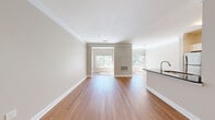 Located at 499 Boston Rd in Billerica, MA, this well-designed one-bedroom, one-bathroom residence offers a thoughtfully organized single-floor layout with a generous mix of living spaces. The open-concept living and dining area is anchored by warm hardwood flooring, crown molding, and multiple windows that invite abundant natural light and views of the surrounding greenery. A peninsula-style kitchen features dark granite countertops, white shaker cabinetry, stainless steel appliances including a refrigerator and range, and an arched architectural detail that leads into a dedicated laundry area with tile flooring. The bedroom is carpeted for comfort, bathed in natural light from a large window with outdoor views, and complemented by a walk-in closet outfitted with wire shelving systems. Two additional closets provide ample storage throughout the unit. A full bathroom includes a soaking tub with tiled surround and chrome fixtures, alongside a granite-topped vanity. A separate office space adds functional versatility. The neutral color palette, clean finishes, and cohesive design create a bright, comfortable ambiance throughout this well-appointed Billerica residence.