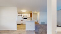 Located at 1307 Tittabawassee Rd in Saginaw, Michigan, this single-floor, three-bedroom, two-bathroom home offers a practical and comfortable layout. The kitchen is a standout feature, equipped with ample white cabinetry accented by warm wood trim, white appliances including a refrigerator and electric range, a stainless steel sink, and a peninsula that opens toward the living area — ideal for casual dining and entertaining. Light wood-style flooring runs through the kitchen and bathrooms, while plush carpet adds warmth to the bedrooms and living spaces. The living area is bright and open, featuring a large window with vertical blinds and a pass-through opening to the kitchen that enhances the sense of connectivity. Each bedroom is generously proportioned, with carpet flooring, standard closets, and natural light from exterior windows. The primary bedroom includes a double-door closet for added storage. Both bathrooms are clean and functional, each offering a vanity with under-sink storage, a mirror, a toilet, and a tub-shower combination, all finished with light wood-style flooring. A connecting hallway ties the rooms together efficiently. The overall design is clean, neutral, and move-in ready.