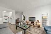 Located in the vibrant Hillcrest neighborhood of San Diego, this single-floor residence at 4250 Fourth Ave offers a well-designed layout with a clean, contemporary aesthetic throughout. Light-toned wood-style flooring runs seamlessly across the entire unit, complementing the crisp white walls and textured ceilings.

The open-plan living and dining area forms the heart of the home. The living room is generously sized, featuring large floor-to-ceiling windows with vertical blinds that flood the space with natural light. The dining area accommodates a glass-top table with wicker and upholstered seating, and is finished with a modern ceiling fan overhead.

The kitchen is fully equipped with white shaker-style cabinetry, light quartz-look countertops, a GE electric range with overhead microwave, and a stainless steel sink — offering ample storage and counter space for everyday cooking.

Both bedrooms are comfortably proportioned, each featuring large windows that bring in natural light and outdoor views of the surrounding neighborhood. The rooms provide a calm, restful atmosphere with clean white walls and warm wood flooring.

The bathroom features a full tub-shower combination with tile surround, a vanity with mirrored storage, and a clean, all-white finish that gives the space a fresh, functional character throughout.
