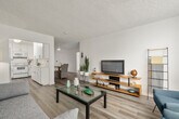 Located in the vibrant Hillcrest neighborhood of San Diego, this single-floor residence at 4250 Fourth Ave offers a well-designed layout with a clean, contemporary aesthetic throughout. Light-toned wood-style flooring runs seamlessly across the entire unit, complementing the crisp white walls and textured ceilings.

The open-plan living and dining area forms the heart of the home. The living room is generously sized, featuring large floor-to-ceiling windows with vertical blinds that flood the space with natural light. The dining area accommodates a glass-top table with wicker and upholstered seating, and is finished with a modern ceiling fan overhead.

The kitchen is fully equipped with white shaker-style cabinetry, light quartz-look countertops, a GE electric range with overhead microwave, and a stainless steel sink — offering ample storage and counter space for everyday cooking.

Both bedrooms are comfortably proportioned, each featuring large windows that bring in natural light and outdoor views of the surrounding neighborhood. The rooms provide a calm, restful atmosphere with clean white walls and warm wood flooring.

The bathroom features a full tub-shower combination with tile surround, a vanity with mirrored storage, and a clean, all-white finish that gives the space a fresh, functional character throughout.