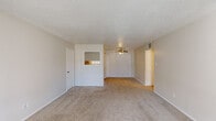 Located at 2800 S 25th St in Abilene, Texas, this single-story residence offers three bedrooms and two bathrooms across a well-utilized floor plan. The open living area is finished with neutral-toned carpet and features a textured ceiling, a ceiling fan with light fixture, and a pass-through window connecting to the kitchen, creating an airy, connected feel throughout the main living space.

The galley-style kitchen is efficiently designed with gray cabinetry lining both walls, white appliances including an electric range and refrigerator, a double-basin stainless steel sink beneath a window, and durable hardwood-style flooring. A textured ceiling and overhead lighting complete the functional workspace.

The generously sized primary bedroom offers ample room and includes a walk-in closet with dual shelving rods on both sides. The additional bedrooms feature carpet flooring, ceiling fans, natural light from windows, and sliding or hinged closet doors for convenient storage.

Both bathrooms are clean and functional. One includes a vanity with a stone-look countertop, a large mirror with overhead lighting, and hardwood-style flooring. The second bathroom features a tiled tub-and-shower combination with chrome fixtures. A hallway connects the bedrooms and living areas, rounding out this practical and comfortable Abilene residence.
