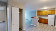 Located at 887 Asylum Ave in Hartford, CT, this one-bedroom, one-bathroom unit offers a practical and efficiently designed single-floor layout. Light wood-style flooring runs consistently throughout the space, lending a clean, cohesive look to every room.

The open-concept kitchen and living area forms the heart of the unit. The kitchen features warm honey-toned wood cabinetry with ample upper and lower storage, granite-style countertops, a stainless sink, and a full-size refrigerator and range. A half-wall peninsula visually separates the kitchen from the living area while maintaining an open, connected feel. The living area is generously proportioned, with a window that brings in natural light and baseboard heating along the perimeter.

The bedroom is a comfortable, well-sized room featuring two windows that allow natural light to fill the space. It includes a dedicated closet with bifold doors, offering practical storage. Baseboard heating is present here as well. Additional closet space is found in the hallway, further enhancing storage options throughout the unit.

The bathroom is clean and straightforward, featuring a full tub and shower combination with white tile surround, a vanity with sink, and dark tile flooring. The overall layout is functional and well-maintained, making this a practical Hartford residence.