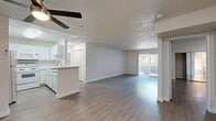 Located at 4335 Vineland Ave in the North Hollywood neighborhood of Los Angeles, this 2-bedroom, 2-bathroom residence offers a well-designed single-floor layout with a clean, modern aesthetic throughout. The open-concept living and dining area is bright and airy, featuring light hardwood-style flooring, a textured ceiling, and a ceiling fan that enhances airflow. Sliding glass doors with vertical blinds allow generous natural light to fill the space while providing outdoor access. The kitchen is outfitted with white cabinetry, a peninsula with a light stone-style countertop, a full suite of white appliances including a refrigerator, electric range, built-in microwave, and dishwasher, along with a stainless steel sink — creating a functional and cohesive cooking space. A hallway with a louvered closet connects the main living areas to the bedrooms and bathrooms. The spacious primary bedroom features a mirrored sliding closet and a window with natural light. Both bathrooms are finished in a clean, all-white palette with tub-shower combinations and hardwood-style flooring. The second bedroom offers a comfortable footprint with neutral walls and consistent flooring. The overall ambiance is light, neutral, and move-in ready.