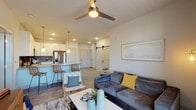 Located at 1330 Kelly Johnson Blvd in Colorado Springs, Colorado, this single-floor residence offers a thoughtfully designed open-concept layout with contemporary finishes throughout. The living area is anchored by a ceiling fan, wood-look flooring, and large windows that invite natural light and outdoor views, creating a bright and welcoming atmosphere. A sliding barn door adds a distinctive architectural touch, seamlessly connecting spaces with style.

The kitchen is well-equipped with stainless steel appliances, crisp white cabinetry extending to the ceiling, a bold geometric tile backsplash, and a quartz-topped peninsula with bar seating — ideal for both casual dining and entertaining. Pendant lighting above the peninsula adds a modern accent.

The bedrooms offer plush carpeting, generous windows with views of the surrounding area, and ceiling fans for year-round comfort. The primary bathroom features a double-sink vanity with quartz countertops, white cabinetry, and a walk-in glass-enclosed tile shower, combining functionality with clean, modern aesthetics. A second bathroom provides a dual-sink setup with ample counter space and well-lit mirrors. Wood-look flooring flows consistently through the main living areas, tying the home's design together cohesively.