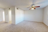 Located at 711 S Lincoln Ave in Clearwater, Florida, this two-bedroom, one-bathroom residence is laid out on a single floor with a clean, straightforward floor plan. The interior features a neutral color palette throughout, with white walls and textured ceilings that lend a bright, open feel to the space.

The living area is carpeted and illuminated by a pendant light fixture, offering a welcoming entry point into the home. Both bedrooms are generously sized, with the primary bedroom being notably spacious. Each bedroom features soft carpeting, ceiling fans with integrated lighting, and access to dedicated closets. Natural light filters into the bedrooms through windows, creating a bright and comfortable environment.

The bathroom is finished with wood-look flooring and includes a full bathtub and shower combination, a toilet, and a vanity, all presented in a clean, white finish. A utility area with wood-look flooring and washer/dryer connections provides added convenience.

The kitchen is positioned toward the front of the unit and is equipped with standard cabinetry and appliances. Throughout the home, consistent hard-surface flooring in the non-carpeted areas ties the functional spaces together cohesively. The overall layout is efficient, making practical use of the available space across each room.