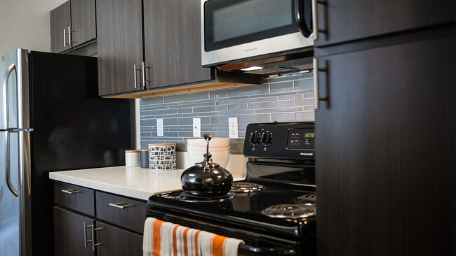 Cocina del apartamento con electrodomésticos de acero inoxidable y encimeras de cuarzo. - Griffis Lafayette Station