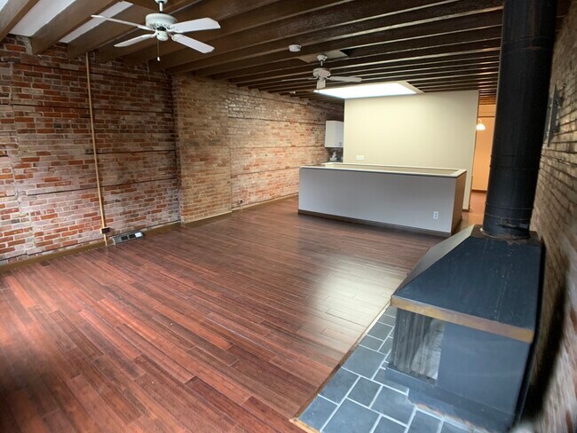 Large living room with hardwood floors, ceiling fans - 182 N Pearl St