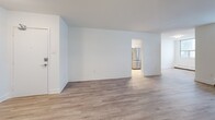 Located on the 11th floor at 2450 Weston Rd in Toronto, this well-appointed 2-bedroom, 1-bathroom unit offers a thoughtfully designed layout with modern finishes throughout. Light-toned hardwood-style flooring flows seamlessly across the open living and dining areas, creating a bright and cohesive feel. Large windows in the living room invite ample natural light and connect to a private balcony enclosed with safety netting and glass railings, offering open city views of the surrounding Toronto skyline. The kitchen is fully updated with white shaker-style cabinetry, a subway tile backsplash, dark countertops, and a full suite of stainless steel appliances including a French door refrigerator, stove, built-in microwave, and dishwasher. The spacious primary bedroom provides generous room for furnishings and features a mirrored sliding closet. The second bedroom also benefits from natural light and its own window with city-facing views. The bathroom is finished with white subway tile surrounding a full soaker tub and shower combination, complemented by clean chrome fixtures. A dedicated hallway and closet complete the functional layout, making this a well-rounded unit suited for comfortable urban living in the Weston neighbourhood.