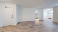 Located on the 11th floor at 2450 Weston Rd in Toronto, this well-appointed 2-bedroom, 1-bathroom unit offers a thoughtfully designed layout with modern finishes throughout. Light-toned hardwood-style flooring flows seamlessly across the open living and dining areas, creating a bright and cohesive feel. Large windows in the living room invite ample natural light and connect to a private balcony enclosed with safety netting and glass railings, offering open city views of the surrounding Toronto skyline. The kitchen is fully updated with white shaker-style cabinetry, a subway tile backsplash, dark countertops, and a full suite of stainless steel appliances including a French door refrigerator, stove, built-in microwave, and dishwasher. The spacious primary bedroom provides generous room for furnishings and features a mirrored sliding closet. The second bedroom also benefits from natural light and its own window with city-facing views. The bathroom is finished with white subway tile surrounding a full soaker tub and shower combination, complemented by clean chrome fixtures. A dedicated hallway and closet complete the functional layout, making this a well-rounded unit suited for comfortable urban living in the Weston neighbourhood.