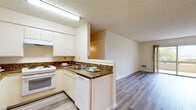 Located at 3553 Emerald St in Torrance, California, this single-floor residence offers three bedrooms and three full bathrooms across a well-organized layout. The kitchen is thoughtfully designed with white cabinetry, rich granite-look countertops, a peninsula with a double sink, a white range, and a dishwasher — all set over light wood-style flooring. The kitchen opens directly to the living area, which is bright and airy with the same wood-style flooring, neutral walls, and a sliding glass door that leads to a private balcony with pleasant outdoor views. The spacious primary bedroom features soft carpeting and a mirrored sliding closet, while the additional bedrooms are similarly carpeted and well-sized. The bathrooms are clean and functional, each featuring wood-style flooring, with at least one offering an extended vanity with a large mirror and a separate water closet with a tiled shower-tub combo. Throughout the residence, textured ceilings, warm neutral tones, and consistent finishes create a cohesive and comfortable ambiance. This well-laid-out home in the heart of Torrance offers a practical and inviting living environment.
