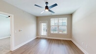 Located at 640 Lakeside Dr in Canton, GA, this thoughtfully designed single-story residence offers a clean, modern aesthetic throughout its well-utilized floor plan. The open-concept kitchen and living area serves as the heart of the home, featuring bright white shaker cabinetry with matte black hardware, a marble-style tile backsplash, stainless steel appliances including a French door refrigerator and over-the-range microwave, and a central island with an undermount sink — ideal for both cooking and casual dining. Light-toned hardwood-style flooring flows seamlessly through the main living areas, enhancing the bright, airy feel of the space. The living room offers access to an outdoor balcony through a glass-paneled door, with a ceiling fan overhead and natural light streaming through large windows with views of the surrounding community. The generously sized bedroom is finished with plush carpet, a ceiling fan, and ample natural light from a wide window. It connects to a walk-in closet with wire shelving for organized storage. The bathroom features white cabinetry, a white quartz countertop, and a soaking tub. A dedicated laundry area completes this efficiently designed and move-in-ready home.