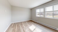 Located at 1110 S Wells St in Lake Geneva, Wisconsin, this 2-bedroom, 1-bathroom residence offers a well-organized single-floor layout designed for comfortable everyday living. The interior features a neutral, contemporary color palette with light gray walls and warm-toned luxury vinyl plank flooring throughout the main living and kitchen areas.

The kitchen is a standout feature, showcasing white shaker-style cabinetry, granite-look countertops, stainless steel appliances including a refrigerator, electric range, and microwave, as well as a dishwasher and an in-unit washer. A pendant light adds a decorative touch above the sink area.

The living room receives natural light through a sliding glass door that opens to an outdoor view, and is equipped with a ceiling fan. The primary bedroom is a comfortable size and includes a closet, while the second bedroom features light luxury vinyl plank flooring, a bright window with natural light, and baseboard heating. Both bedrooms are finished in soft neutral tones.

The bathroom is clean and functional, featuring a full tub-shower surround with built-in shelving, wood-look flooring, and white fixtures. Throughout the home, baseboard heating, ample closet space, and a cohesive modern aesthetic make this residence a practical and inviting option in Lake Geneva.