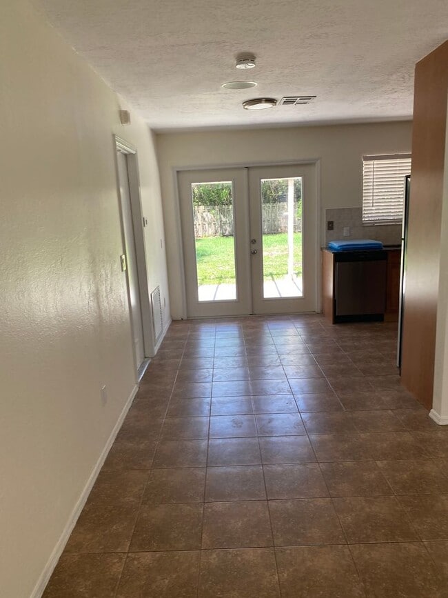 Building Photo - 2/2/1 home with a spacious fenced backyard...