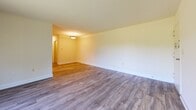 Located at 804 Roundtop Ct in Lutherville Timonium, Maryland, this single-floor, three-bedroom, one-bathroom home offers a well-organized layout with a practical and modern aesthetic. Consistent wood-look flooring flows throughout the entire space, complementing the crisp white walls and clean-lined trim that define each room.

The living room is a generously proportioned open area with flush ceiling lighting and a warm, neutral palette, providing a welcoming entry point into the home. Adjacent to it, the galley-style kitchen is a functional standout, featuring rich dark-wood cabinetry, granite countertops with an undermount sink, and stainless steel appliances including a gas range and refrigerator — offering both style and practicality.

The primary bedroom is a spacious retreat with access to two closets and a connecting hallway leading to the full bathroom. The additional two bedrooms are well-sized, each featuring natural light from windows with blinds and individual closet access. The shared full bathroom includes a dark-wood vanity with a large mirror, a light tile floor, and a tub-shower combination, all finished with clean, modern fixtures.

Each room benefits from the home's bright, airy atmosphere, neutral tones, and functional design — making this Timonium residence a comfortable and move-in ready living space.