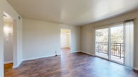 Located at 1420 F St in Davis, CA, this 2-bedroom, 1-bathroom unit offers a well-organized single-floor layout designed for comfortable everyday living. The living room serves as the heart of the home, showcasing rich dark hardwood-style flooring, neutral beige walls, and a sliding glass door that opens to a private balcony with views of surrounding greenery — filling the space with abundant natural light. The entry area continues the hardwood-style flooring, creating a cohesive flow throughout the main living areas. The kitchen features warm yellow cabinetry, dark granite-style countertops, a stainless steel sink, and a full suite of appliances including an electric range with overhead ventilation — efficiently utilizing every inch of the space. Both bedrooms are carpeted for comfort, each benefiting from large windows that invite natural light and offer pleasant outdoor views of mature trees and landscaping. The shared full bathroom includes a tub-shower combination, a white vanity with storage, a mirrored medicine cabinet, and wood-style tile flooring. Two closets provide practical storage solutions throughout the unit. The overall ambiance is clean, bright, and functional, reflecting a well-maintained home in a convenient Davis location.
