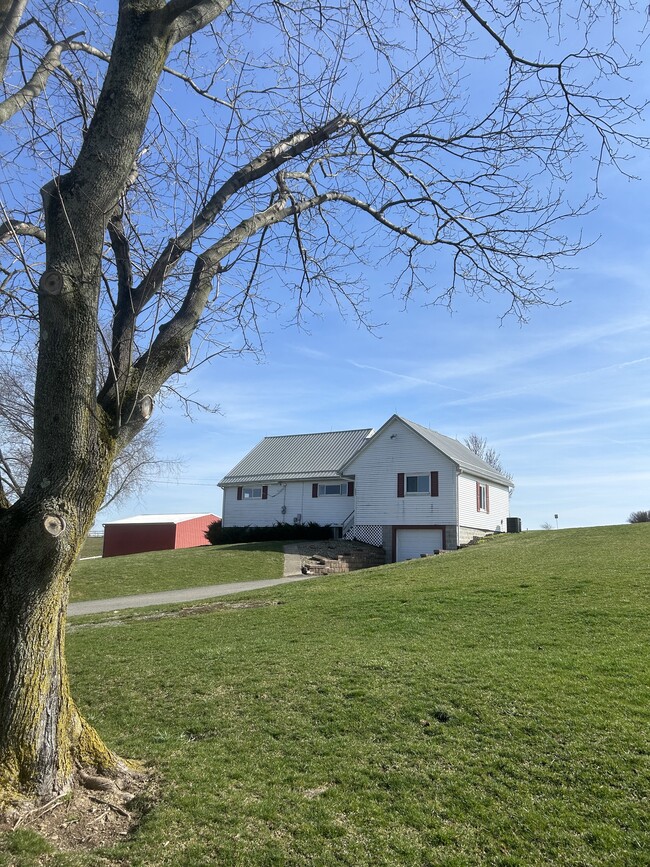 Front of house. Garage and plenty of outdoor parking space. - 203 Reibold Rd