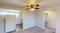 Located at 3 Marhoefer Dr in Pleasant Hills, PA, this single-floor residence offers three bedrooms, one bathroom, a kitchen, and a hallway, making efficient use of its compact footprint. The layout is straightforward and functional, with neutral-toned walls and plush carpeting running throughout the living and bedroom areas.

Each bedroom is equipped with a ceiling fan with integrated lighting, providing both comfort and illumination. The generously sized primary bedroom offers ample space and connects to adjacent rooms through an open doorway. The additional bedrooms feature natural light from windows with blinds and include ceiling fans, with at least one bedroom offering a built-in closet with a rod for storage.

The entry area features carpeted flooring, a wall-mounted air conditioning unit, and a large window that allows natural light to fill the space. The kitchen is outfitted with dark wood cabinetry, light countertops, a stainless steel sink, a gas range, a dishwasher, and wood-look flooring — providing a practical cooking and prep space.

The bathroom features a clean, white-tiled tub and shower combination with a window for natural ventilation, chrome fixtures, a grab bar, and a vanity with sink. Baseboard heating is present throughout, ensuring year-round comfort in this well-maintained Pleasant Hills residence.