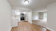 Located at 1547 W Irving Park Rd in Itasca, Illinois, this one-bedroom, one-bathroom residence offers a well-organized, single-floor layout designed for comfortable everyday living. The open-concept kitchen and dining area is a standout feature, showcasing crisp white shaker cabinets, bright white countertops, and a full suite of stainless steel appliances including a refrigerator, electric range, microwave, and dishwasher. Light wood-style flooring runs throughout the kitchen and dining space, creating a clean and modern aesthetic. The living room is generously proportioned with plush carpeting, baseboard heating, a wall-mounted air conditioning unit, and sliding glass doors that open to a private patio with outdoor views. The spacious bedroom features soft carpet flooring, a large window that draws in natural light, and access to a dedicated walk-in closet, complemented by two additional closets throughout the unit. The full bathroom is finished in an all-white palette with a single-sink vanity, a tub-shower combination, and wood-style flooring. A dedicated laundry area adds everyday convenience. With its updated finishes and functional layout, this residence offers a polished and practical living environment.