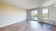 Located at 500 N Andrews Ave in the heart of Fort Lauderdale, FL, this modern 2-bedroom, 1-bathroom unit offers a well-designed single-floor layout with clean, contemporary finishes throughout. Wood-look plank flooring runs continuously across the living areas and bedrooms, lending warmth and cohesion to the space.

The kitchen is a standout feature, outfitted with sleek flat-front white cabinetry extending to the ceiling, a marble-style tile backsplash, and stainless steel appliances including a French-door refrigerator, electric range, built-in microwave, and dishwasher. A neutral-toned countertop and undermount sink complete the functional, modern aesthetic.

The living area is bright and open, highlighted by a sliding glass door that leads to a private balcony offering views of the surrounding Fort Lauderdale cityscape and greenery. The primary bedroom is generously proportioned, while the second bedroom provides flexible space with recessed lighting and ample wall space.

The bathroom is finished in crisp white marble-look tile, featuring a soaking tub with an overhead rain showerhead and chrome fixtures, creating a clean and spa-like feel. Throughout the unit, neutral wall tones and consistent flooring create a cohesive, move-in-ready environment ideal for urban living.