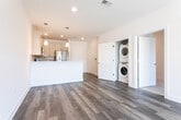 Located at Whitty Road in Toms River, New Jersey, this single-floor residence offers a thoughtfully designed layout with contemporary finishes throughout. The open-concept living area features wood-look plank flooring in a cool gray tone, recessed lighting, and large windows that invite an abundance of natural light, creating a bright and airy atmosphere. A ceiling fan enhances comfort in the spacious living space, which also provides access to a private outdoor area through sliding glass doors dressed with vertical blinds.

The kitchen is well-equipped with stainless steel appliances including a gas range, over-the-range microwave, and a French door refrigerator. Soft-tone shaker-style cabinetry, a tile backsplash, and wood-look flooring give the kitchen a clean, modern aesthetic. A breakfast bar adds both functionality and style to the space.

The bedrooms feature plush wall-to-wall carpeting and crisp white walls, offering a quiet and comfortable retreat. The bathrooms are finished with light-toned tile flooring and vanities with ample storage. The primary bathroom stands out with elegant marble-look tile surrounding a soaking tub and shower combination, complemented by matching floor tile. An in-unit laundry area adds everyday convenience to this well-rounded residence.