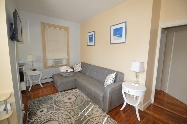 A wall mounted TV in the living room - 87 Spring St