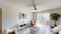Located at 2140 West Thunderbird Road in Phoenix, AZ, this one-bedroom, two-bathroom residence offers a thoughtfully designed single-floor layout. Light wood-style flooring flows throughout the space, creating a cohesive and contemporary feel.

The open-concept living room is bright and welcoming, featuring a ceiling fan with integrated lighting and a sliding glass door fitted with vertical blinds that fills the room with natural light while providing direct access to an outdoor patio. The adjoining kitchen is well-appointed with white shaker cabinetry, subway tile backsplash, gray countertops, and a full suite of stainless steel appliances including a refrigerator, electric range, over-the-range microwave, and dishwasher. A peninsula counter provides added workspace and casual dining potential.

The bedroom is a comfortable retreat with its own ceiling fan, a natural light window with blinds, and wood-style flooring. A dedicated closet offers organized storage. The two bathrooms are clean and functional — one features a wide vanity with gray countertop and cabinetry, while the second includes a full shower/tub combination. Textured ceilings are consistent throughout, adding a classic touch to this efficiently designed Phoenix residence.