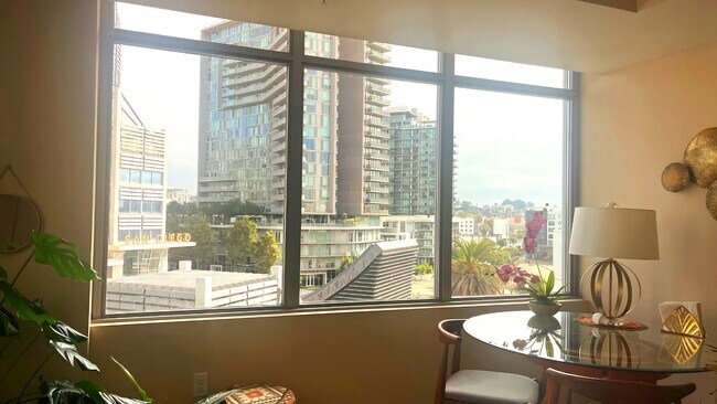 Bright living room wi windows showcasing stunning city views. - 206 Park Blvd