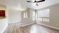 Located at 20251 N 75th Ave in Glendale, Arizona, this two-bedroom, two-bathroom single-floor residence offers a thoughtfully designed layout with a blend of comfort and modern finishes throughout. The open living area features light wood-look tile flooring, neutral-toned walls, and a ceiling fan, with multiple windows dressed in blinds that bring in generous natural light and views of the surrounding landscape. The kitchen is a standout, showcasing rich cherry wood cabinetry, granite countertops, and a full suite of stainless steel appliances including a gas range, microwave, dishwasher, and refrigerator — all set atop matching wood-look flooring for a cohesive aesthetic. Both bedrooms are carpeted and equipped with ceiling fans, offering a comfortable retreat. The primary bedroom benefits from vaulted ceilings, direct access to its own bathroom featuring a granite-topped vanity with cherry cabinetry, and a walk-in closet with dual hanging rods and shelving. The second bedroom includes two side-by-side closets with paneled doors. The bathrooms each feature a full tub-shower combination with white tile surround and wood-look flooring. A dedicated hallway connects all rooms, contributing to an efficient and functional floor plan throughout this well-finished Glendale residence.