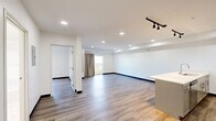 This well-appointed 3-bedroom, 2-bathroom residence at 1951 E Sternberg Rd in Muskegon, MI offers a clean, modern aesthetic throughout its thoughtfully designed single-floor layout. Wide-plank wood-look flooring flows seamlessly through the living spaces, complemented by crisp white walls and bold dark baseboards that add definition to each room.

The open-concept kitchen and living area serves as the heart of the home. The kitchen is outfitted with gray shaker-style cabinetry, quartz countertops, a large center island with an undermount sink, and stainless steel appliances including a range, dishwasher, and refrigerator. Industrial-style track lighting and recessed fixtures illuminate the space with a contemporary edge.

The spacious living room features a ceiling fan, recessed lighting, and a sliding glass door that opens to a private balcony, flooding the room with natural light and offering pleasant outdoor views. The generously sized primary bedroom includes a walk-in closet with built-in wire shelving — ideal for organized storage.

Both bathrooms are finished with large-format marble-look tile flooring and gray vanities. The primary bath features a sleek glass-enclosed walk-in shower, while the second bathroom offers a full tub-shower combo. The additional bedrooms are bright and versatile, well-suited for a variety of uses.
