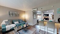 Located at 701 E Bay Dr in Largo, FL, this efficiently designed one-bedroom, one-bathroom unit offers a well-organized single-floor layout that maximizes every square foot. The living room serves as the heart of the space, featuring wood-look flooring, neutral warm-toned walls, a textured ceiling, and a large window that fills the room with natural light — ideal for comfortable everyday living. The kitchen is outfitted with white cabinetry, granite-style countertops, a stainless steel sink, and black appliances including a gas range and microwave, complemented by a breakfast bar that connects seamlessly to the dining and living areas. The bedroom offers a cozy retreat with carpeted flooring, a wall-mounted air conditioning unit for personalized climate control, and sliding glass doors that open directly onto a private balcony with outdoor views. A dedicated closet provides convenient storage. The bathroom features a wide vanity with white cabinetry, granite-style countertops, a large mirror, and a shower-tub combo. Throughout the unit, consistent finishes and thoughtful details create a cohesive, move-in-ready ambiance suited for comfortable Florida living.