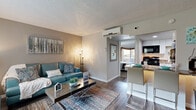 Located at 701 E Bay Dr in Largo, FL, this efficiently designed one-bedroom, one-bathroom unit offers a well-organized single-floor layout that maximizes every square foot. The living room serves as the heart of the space, featuring wood-look flooring, neutral warm-toned walls, a textured ceiling, and a large window that fills the room with natural light — ideal for comfortable everyday living. The kitchen is outfitted with white cabinetry, granite-style countertops, a stainless steel sink, and black appliances including a gas range and microwave, complemented by a breakfast bar that connects seamlessly to the dining and living areas. The bedroom offers a cozy retreat with carpeted flooring, a wall-mounted air conditioning unit for personalized climate control, and sliding glass doors that open directly onto a private balcony with outdoor views. A dedicated closet provides convenient storage. The bathroom features a wide vanity with white cabinetry, granite-style countertops, a large mirror, and a shower-tub combo. Throughout the unit, consistent finishes and thoughtful details create a cohesive, move-in-ready ambiance suited for comfortable Florida living.