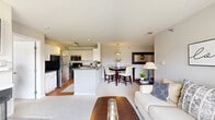 Located at 348 Glenwood Dr in Bloomingdale, IL, this well-appointed single-floor residence offers a thoughtfully designed layout with 1 bedroom, 2 full bathrooms, a dedicated office, and in-unit laundry. The open-concept main living area seamlessly connects the kitchen, dining room, and living room, creating a bright and cohesive space. The kitchen features white cabinetry, stainless steel appliances including a refrigerator and microwave, and a peninsula with counter seating. The dining area is accented by a pendant light fixture and decorative mirror, adding a refined touch. The living room is highlighted by a fireplace and sliding glass doors that open to a private balcony, flooding the space with natural light and offering pleasant outdoor views. Flooring transitions between hardwood and carpet throughout. The primary bedroom is generously sized with a large window that brings in additional natural light. Two closets provide ample storage. Both bathrooms are clean and functional, with one featuring a tiled tub-shower combo and hardwood flooring. The dedicated office offers a quiet, carpeted retreat. A laundry area with washer hookups completes this practical and comfortable home.
