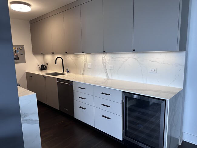 Sleek Italian cabinetry and countertops, Kitchen-Aid appliances, and 14 feet of prep space. - 1325 N State Pky