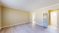 Located at 22027 S Vermont Ave in Torrance, CA, this single-floor, one-bedroom, one-bathroom unit offers an efficiently designed layout. The spacious bedroom is a standout feature, finished with light-toned hardwood-style flooring, warm yellow-beige walls, and elegant crown molding throughout. Gold-framed mirrored sliding closet doors add a reflective touch, enhancing the sense of openness. A window allows natural light to fill the room, creating a bright and airy atmosphere.

The kitchen is thoughtfully appointed with white cabinetry, granite-look countertops, a double stainless steel sink, and a gas range. A window above the sink brings in natural light and provides an outdoor view, while warm tile flooring completes the space.

The bathroom is clean and functional, featuring neutral tile flooring and a window that provides both ventilation and natural light. A hallway connects the rooms, contributing to a smooth and logical flow throughout the unit.

Crown molding details, consistent flooring, and a cohesive warm color palette give the entire space a polished and well-maintained character. The layout, as seen in the 3D model, maximizes every square foot, making this a practical and comfortable Torrance residence.