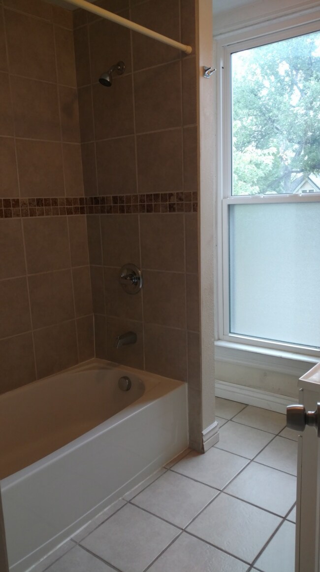 Full bathroom with shower and tub. - 1767 Emerson St