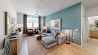 Located in McKinney, TX, this thoughtfully designed 2-bedroom, 3-bathroom single-floor residence blends modern aesthetics with functional living. Light wood-look flooring flows throughout, creating a warm and cohesive feel across every room.

The living room is an inviting focal point, featuring a bold teal accent wall, ceiling fan, and large windows dressed with floor-to-ceiling curtains that fill the space with natural light. The kitchen is sleek and contemporary, showcasing white upper cabinetry, light wood lower cabinets, a white quartz peninsula with bar seating, subway tile backsplash, and a full suite of stainless steel appliances including a side-by-side refrigerator and built-in microwave.

Both bedrooms are bright and airy, each with large windows, ceiling fans, and clean white walls. The primary bedroom connects to a well-appointed en-suite bathroom featuring a dual-sink vanity with wood cabinetry, white quartz countertops, and direct access to a walk-in closet. A second full bathroom mirrors the same refined finishes. Two dedicated closets provide generous storage throughout the residence.

The overall ambiance is clean, modern, and inviting — a well-curated space that balances comfort and contemporary style in a convenient McKinney location.