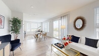 This thoughtfully designed one-bedroom, two-bathroom residence delivers a bright and modern living experience across a single floor. The open-concept living and dining area is anchored by wide-plank light wood flooring, recessed lighting, and an abundance of natural light streaming through large windows and sliding glass doors that lead to a private balcony overlooking scenic outdoor views. The kitchen features sleek white cabinetry, dark granite countertops with a center island, stainless steel appliances, and additional windows that further enhance the airy atmosphere. The spacious primary bedroom is finished with plush carpet, a ceiling fan, and generous windows, and connects to a dedicated closet outfitted with multi-tiered shelving and hanging rods for ample storage. The primary bathroom showcases floor-to-ceiling neutral tile in a walk-in glass-enclosed shower, wood-look flooring, and built-in shelving. The second bathroom offers a floating vanity with dark granite countertops, a large framed mirror, and hardwood-style flooring. Throughout the residence, clean white walls, contemporary fixtures, and a cohesive modern aesthetic create a polished and inviting ambiance.