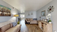 Located in Arlington, TX, this 2-bedroom, 2-bathroom single-floor residence offers a practical and comfortable layout. The open-concept living and dining area is anchored by warm wood-look flooring and soft gray walls, creating a welcoming atmosphere. The living room provides generous space for seating and entertainment, while the adjacent dining area benefits from a sliding glass door that opens to an outdoor balcony, filling the space with natural light and outdoor views.

The galley-style kitchen is efficiently designed with white cabinetry, gray countertops, a gray subway tile backsplash, and a full suite of black appliances. A pantry adds valuable storage to the culinary space.

The spacious primary bedroom features plush carpeting, a large window that invites natural light, and a generously sized walk-in closet with built-in shelving on both sides. The second bedroom, also carpeted, offers comfortable proportions suitable for multiple uses.

Both bathrooms are finished with wood-look flooring, white vanity cabinetry, and granite-style countertops, each equipped with a tub/shower combination. A hallway connects the key areas of the residence, and four total closets throughout ensure ample storage for everyday living.