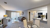 Located at 7670 N Oakbrook Dr in Reynoldsburg, Ohio, this 2-bedroom, 1-bathroom residence offers a thoughtfully designed single-floor layout. The open-concept living and dining area is bright and welcoming, anchored by sliding glass doors dressed with vertical blinds that invite natural light and provide outdoor access. Soft carpet flows throughout the living spaces, creating a warm and comfortable ambiance.

The kitchen is a standout feature, showcasing crisp white cabinetry, granite countertops, a peninsula with a double sink, and black appliances including a range, microwave, and refrigerator. It connects seamlessly to the dining and living areas, making it ideal for everyday functionality.

The spacious primary bedroom benefits from multiple windows that fill the room with natural light, complemented by plush carpeting and access to a generously sized walk-in closet with wire shelving for ample storage. The second bedroom is cozy and well-proportioned, also featuring carpeting and a closet.

The full bathroom is tastefully finished with wood-look flooring, a white vanity with granite countertop, a large mirror, and a tub-shower combination. A hallway connects all rooms efficiently, completing this practical and comfortable floor plan.