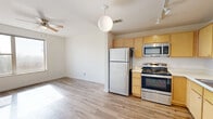 Located at 600 N Stonewall Ave in Oklahoma City, Oklahoma, this two-bedroom, one-bathroom unit offers a functional and efficiently laid-out single-floor living space. The open-concept kitchen flows seamlessly into the living area and is outfitted with light maple cabinetry, stainless steel appliances including a range, microwave, dishwasher, and refrigerator, as well as a double-basin sink and track lighting overhead. Wood-look flooring runs throughout the kitchen and living area, adding warmth and easy maintenance. Both bedrooms are carpeted, providing a comfortable underfoot feel, and are well-lit with natural light streaming through windows. The primary bedroom includes a ceiling fan and a dedicated walk-in closet with built-in shelving and hanging rods, offering ample storage. The second bedroom is cozy and bright, also featuring carpet flooring. The full bathroom is finished with tile flooring, a light wood vanity with a single sink, and a full tub-shower combination. Crisp white walls and neutral tones throughout create a clean, move-in-ready atmosphere suited for comfortable everyday living in Oklahoma City.
