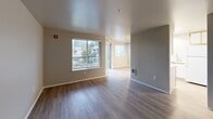 Located at 775 Cascade St in Oregon City, Oregon, this single-floor unit offers a practical and well-organized layout across a comfortable footprint. The living area features hardwood-style flooring and large windows that invite natural light and provide views of the surrounding neighborhood. A sliding glass door leads directly to a private balcony, extending the living space outdoors. A ceiling fan adds comfort to the open living and dining area.

The kitchen is efficiently designed with white cabinetry accented by gold trim, a full suite of white appliances including a range, microwave, refrigerator, and dishwasher, complemented by a skylight that brightens the workspace. Light wood-style flooring runs throughout the kitchen.

The bedroom features plush carpeting, a mirrored sliding-door closet, and a window that fills the room with natural light. A second carpeted room provides flexible space and includes a closet and electrical panel access. The full bathroom is finished with wood-style flooring, a single vanity, and a shower/tub combination. A dedicated laundry area houses a full-size washer and dryer with overhead shelving. The entrance and hallway provide a smooth transition throughout the unit.